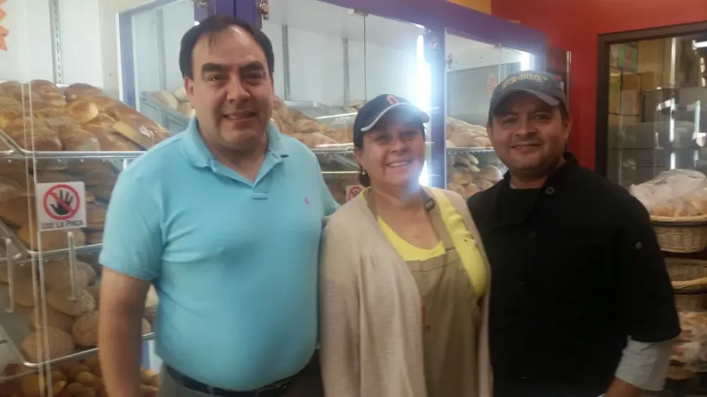 Three members of the Don Paco López team behind the bakery counter