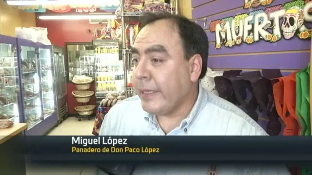 Baker Miguel López interviewed inside the bakery on NY1 Noticias